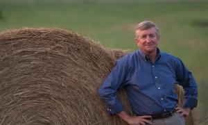 George Wood stands by a hay bale