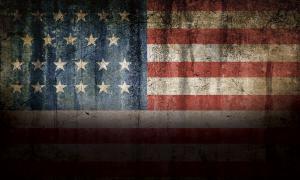An American flag shrouded in shadow