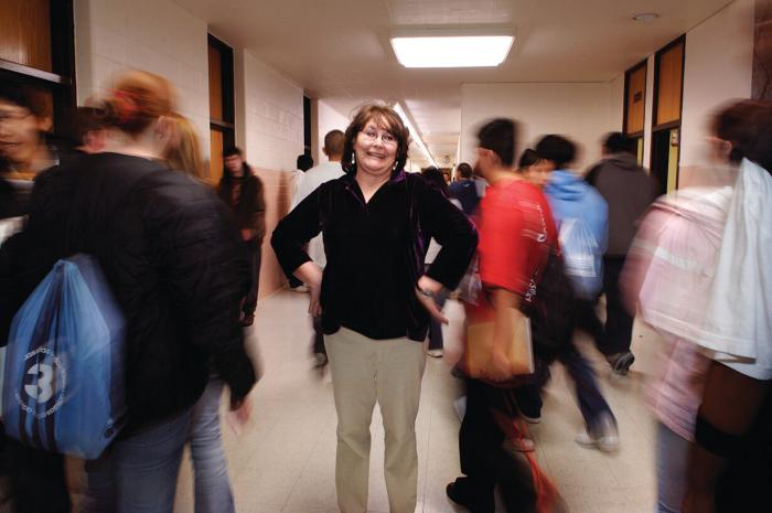 Vicki Sherman in the school halls whith students passing by 