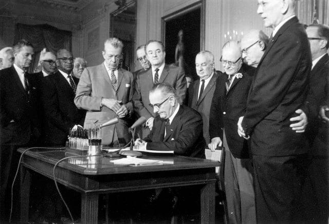 President Lyndon Johnson signs the 24th Amendment.