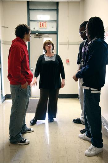 Vickie Malone stands with students in the hallway