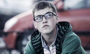 teenage boy with glasses and chin piercing