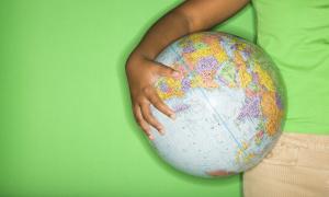student holding a globe