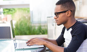 teenage male working at computer