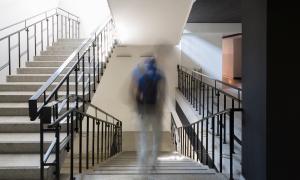 Student walking alone down school hallway