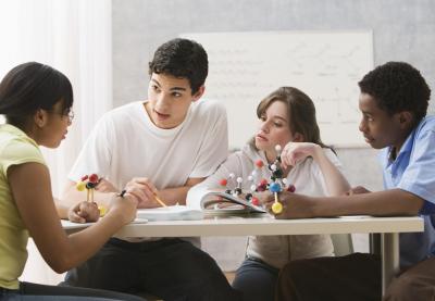 Teens work together on a science problem.