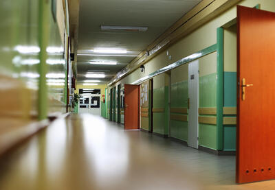 Open doors in a poorly-lit hallway at school after hours