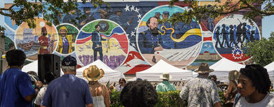 A mural commemorating Juneteenth stretches across the wall of a building. 