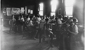  young children at work in an early 20th century factory