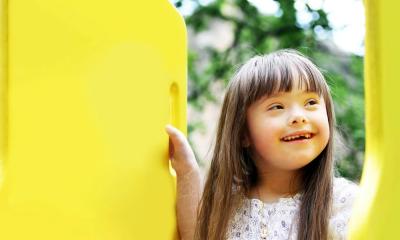 girl on yellow playground equipment