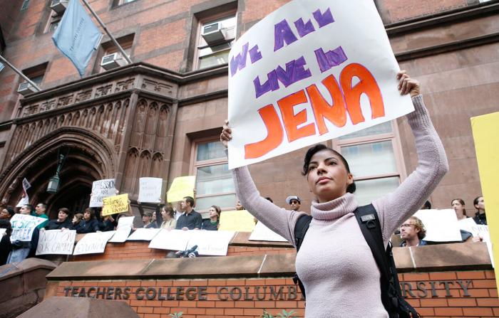 Student hold the message 'We All Live In Jena'