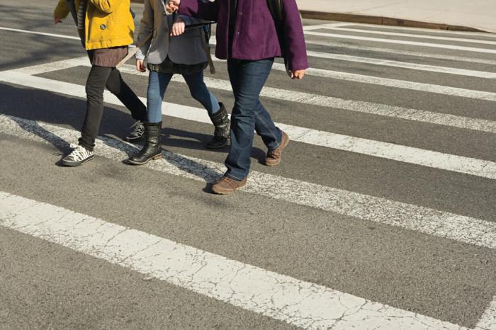 3 Students crossing the road together