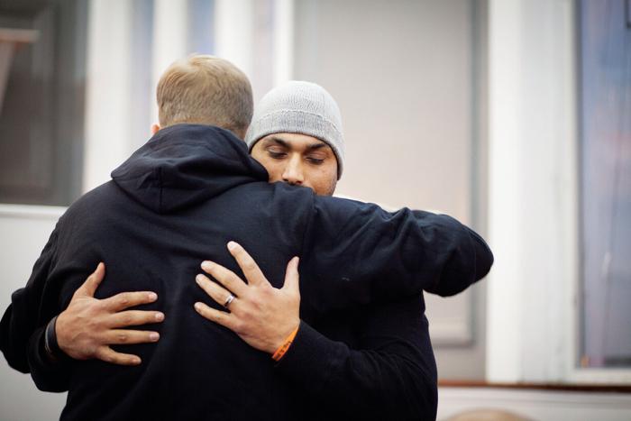 Social study teacher Pardeep Kaleka hugs Arno Michaelis anti-racist activist