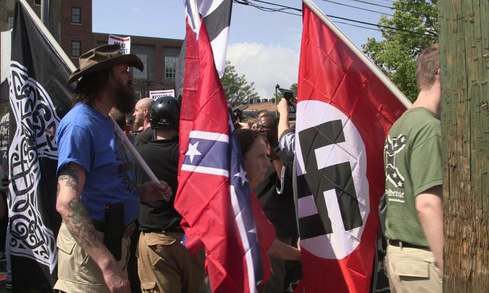 Demonstrators hold shields and flags during the Unite the Right free speech rally at Emancipation Park in Charlottesville, Virginia, USA on August 12, 2017.