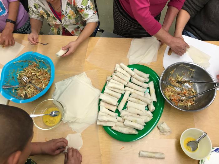 Parents and students cooking in the Culturally Inclusive Cooking Club