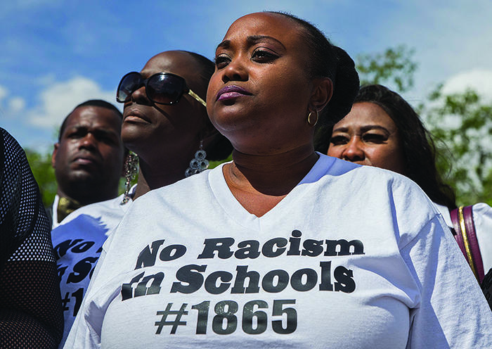 Jshauntae Marshall wears a "No Racism in Schools #1865" shirt during a press conference outside the Clark County Juvenile Justice center.